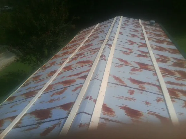 Rusted metal roof panels with new wood purlins before replacement — Storm Damage Roof Repair in Paducah by Roofing Brothers